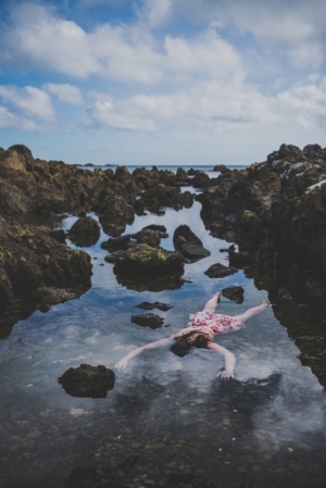 A woman floating face down in the water
